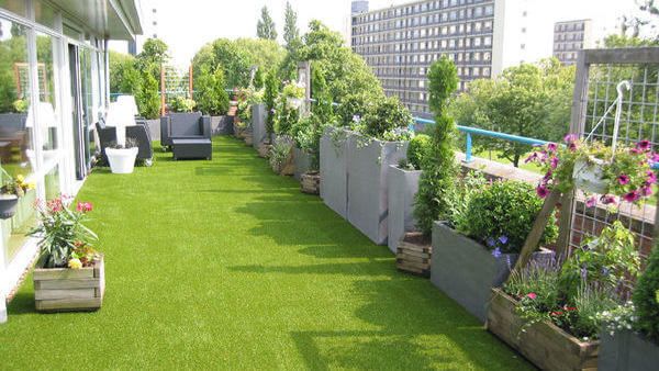 Dakterras met plantenbakken en kunstgras