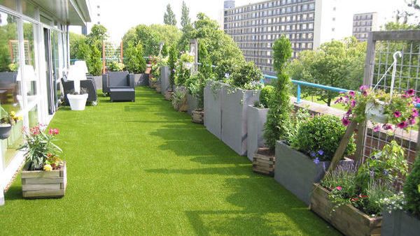 Balkon met plantenbakken en kunstgras